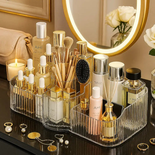 Luxury acrylic makeup organizer holding foundation bottles, brushes, perfume, and skincare products on a vanity
