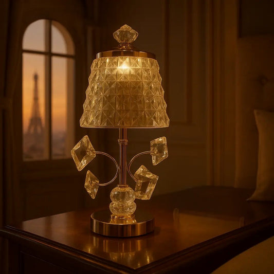 Luxury bedside lamp golden with ornate crystal design and warm glowing light on wooden table