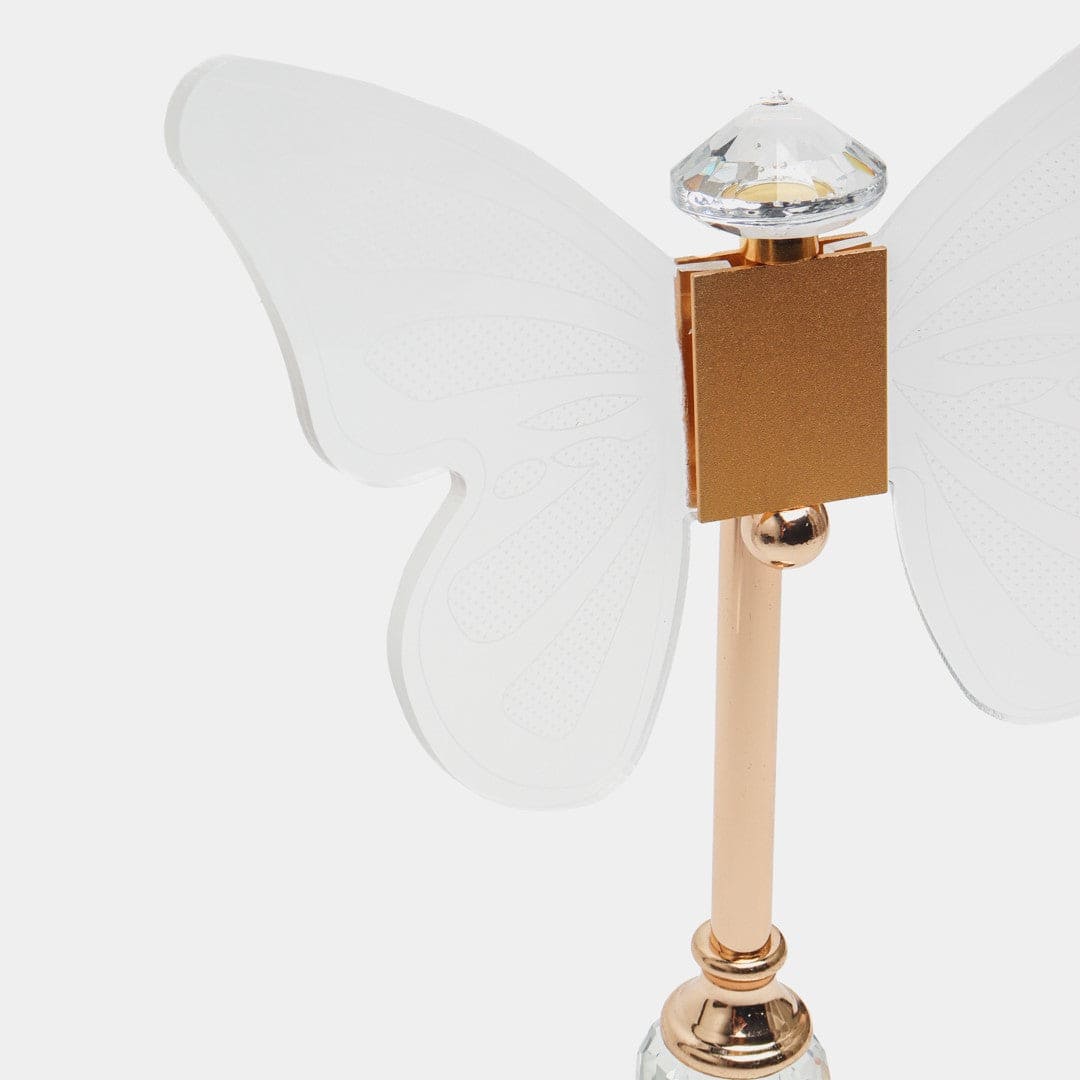 Close-up of elegant butterfly table lamp with clear acrylic wings and gold metallic stand
