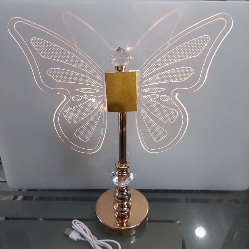 Clarify.pk butterfly table lamp with illuminated clear acrylic butterfly wings and gold base with USB cable