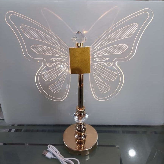 Clarify.pk butterfly table lamp with illuminated clear acrylic butterfly wings and gold base with USB cable