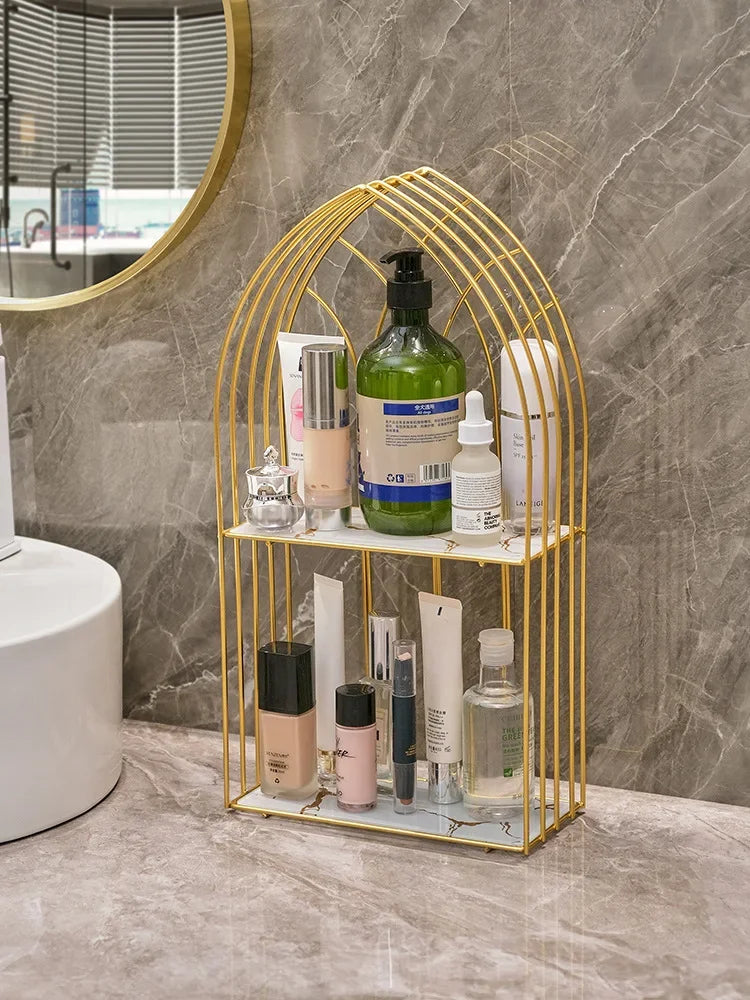 Luxury gold storage rack for bathroom by Clarify.pk holding skincare and cosmetic products on two shelves