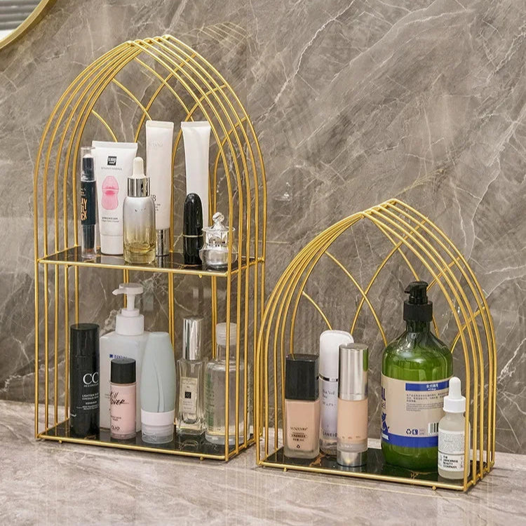 Luxury gold storage rack for bathroom with two-tier metal shelves holding skincare and beauty products