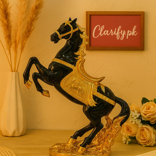 Black and gold luxury horse statue decor with detailed saddle and mane on wooden surface