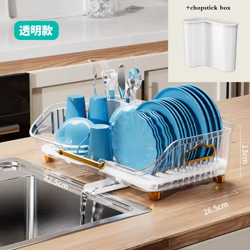 Luxury kitchen dish drainer in transparent design holding blue plates, cups, and silver cutlery on wooden countertop