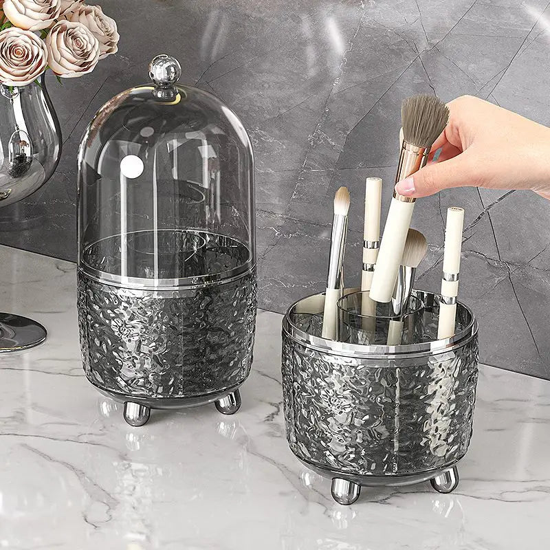 Luxury makeup brush organizer with textured glass design and clear dome cover holding white handle brushes