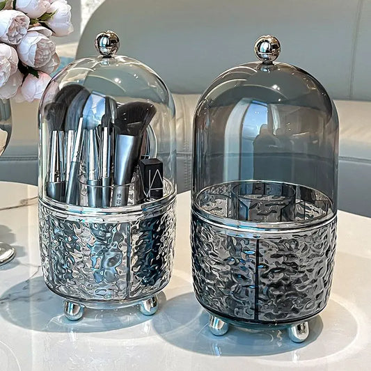 Silver and smoky glass luxury makeup brush organizer with multiple brush slots on white table