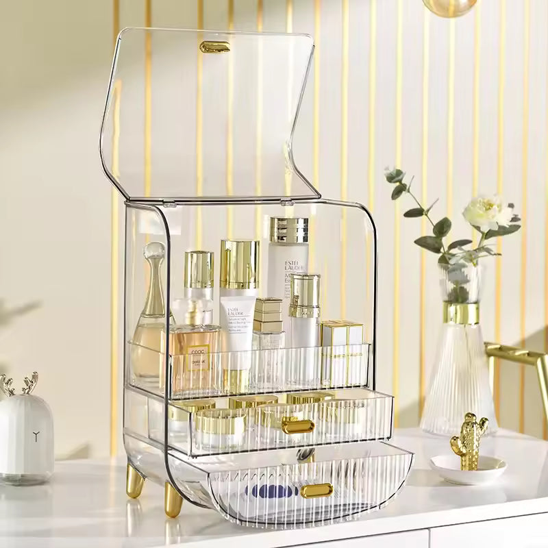 Clear luxury makeup storage box with gold accents holding various skincare and cosmetic products