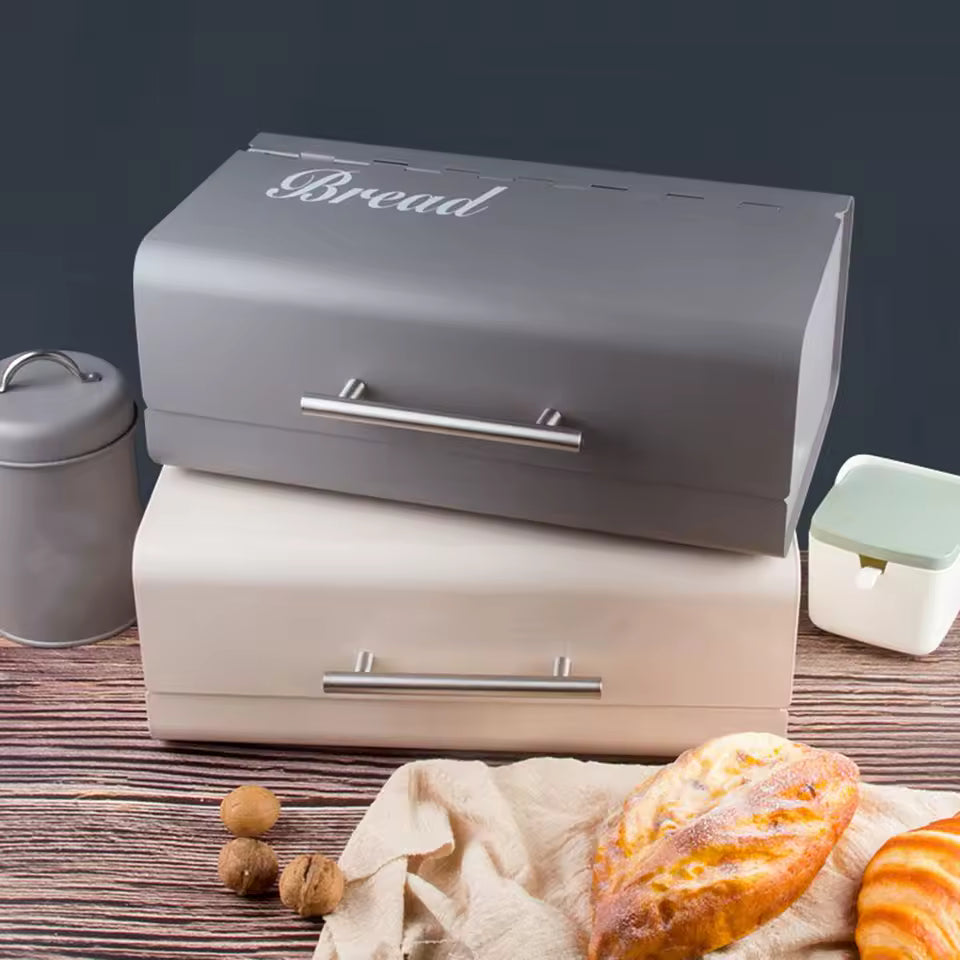 Luxury metal bread box in gray with bread lettering and matching cream bread storage case on wooden surface