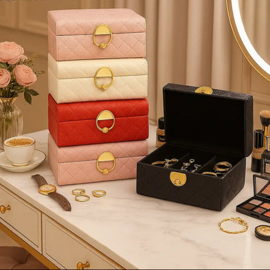 Luxury quilted jewelry organizer box in multiple colors with gold-tone clasps holding rings and accessories