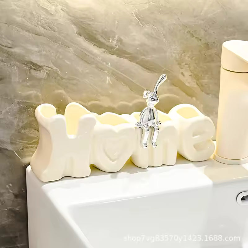 Luxury toothbrush holder for bathroom shaped as white Home letters with silver bunny figure