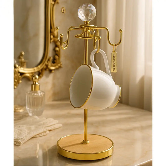 Luxury vanity cup organizer with gold metal frame and wooden base holding a white ceramic cup
