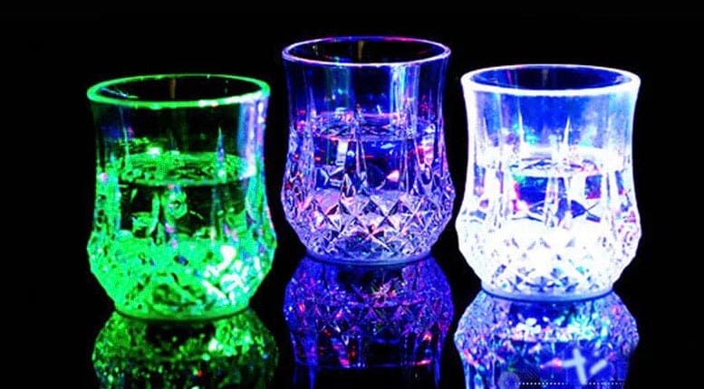 Three illuminated crystal mugs glowing green blue and white magic light up acrylic mug set