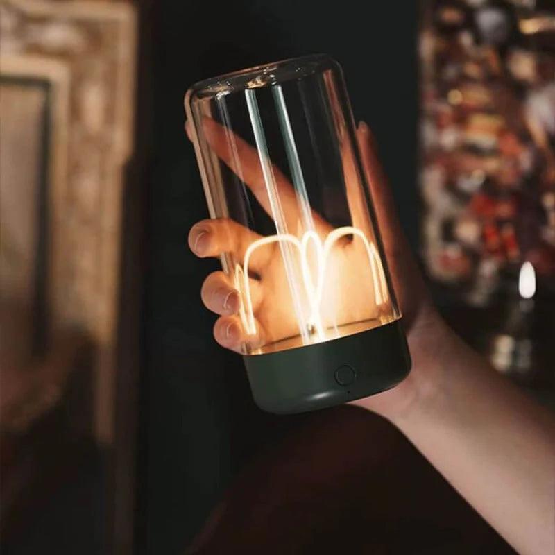 Hand holding a glowing Magnetic LED Desk Light with a modern filament design and transparent casing