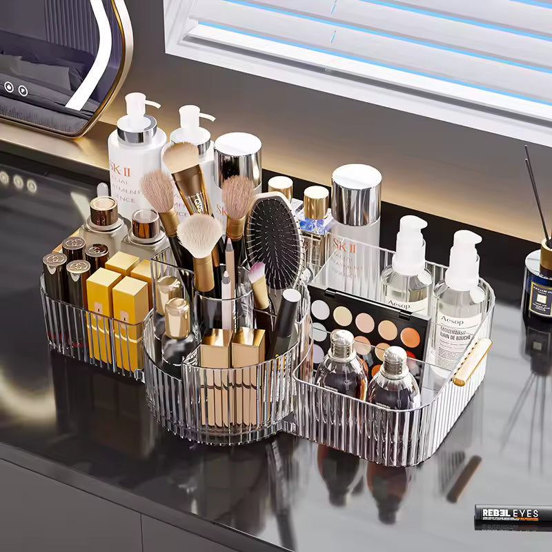 Clear makeup organizer box for vanity holding brushes, lotions, lipsticks, and skincare products on a black countertop