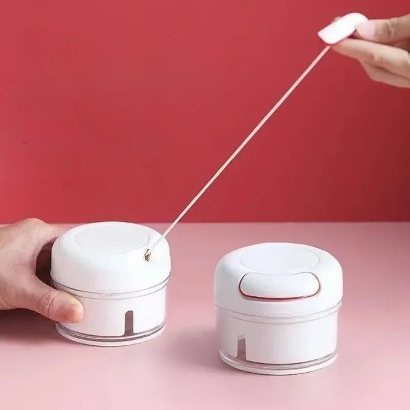 White manual garlic chopper with pull string design for easy garlic chopping by Clarify.pk