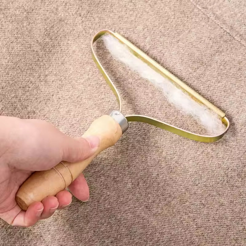Manual lint remover for clothes with wooden handle removing lint from fabric