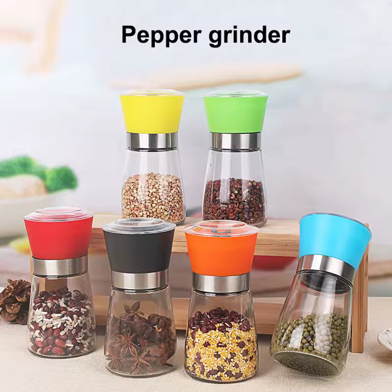 Manual salt and pepper grinder set with colorful tops and clear glass bodies by Clarify.pk