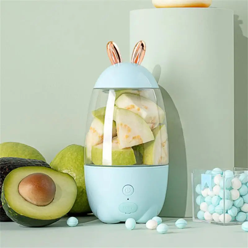 Clarify.pk portable electric juicer with bunny ears design filled with fresh fruit pieces