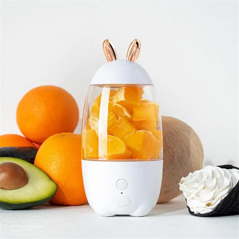 Clarify.pk portable electric juicer with fruit pieces inside and fresh fruits around it