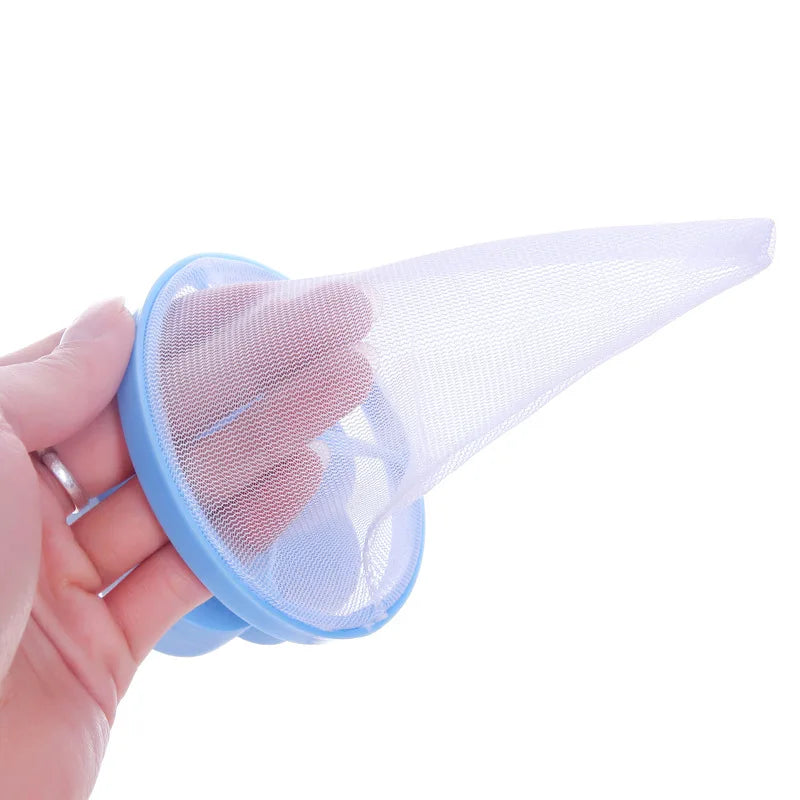Hand holding a blue mesh filter laundry bag for washing machine with fine white mesh netting
