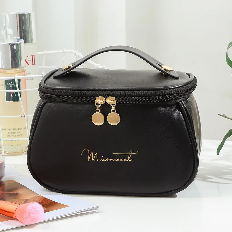 Black portable makeup case with zipper and gold accents by Clarify.pk with top handle