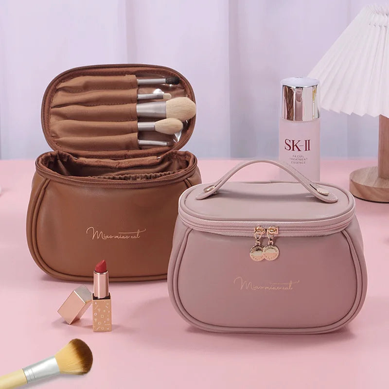 Portable makeup case with zipper in pink and brown colors with makeup brushes and cosmetics inside