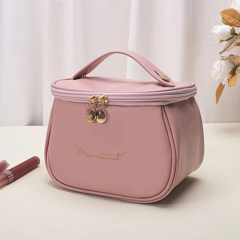 Pink portable makeup case with zipper and handle from Clarify.pk on white surface