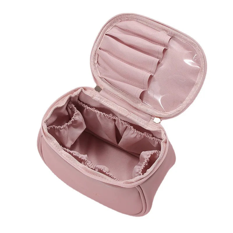 Pink portable makeup case with zipper featuring multiple compartments for cosmetics organization