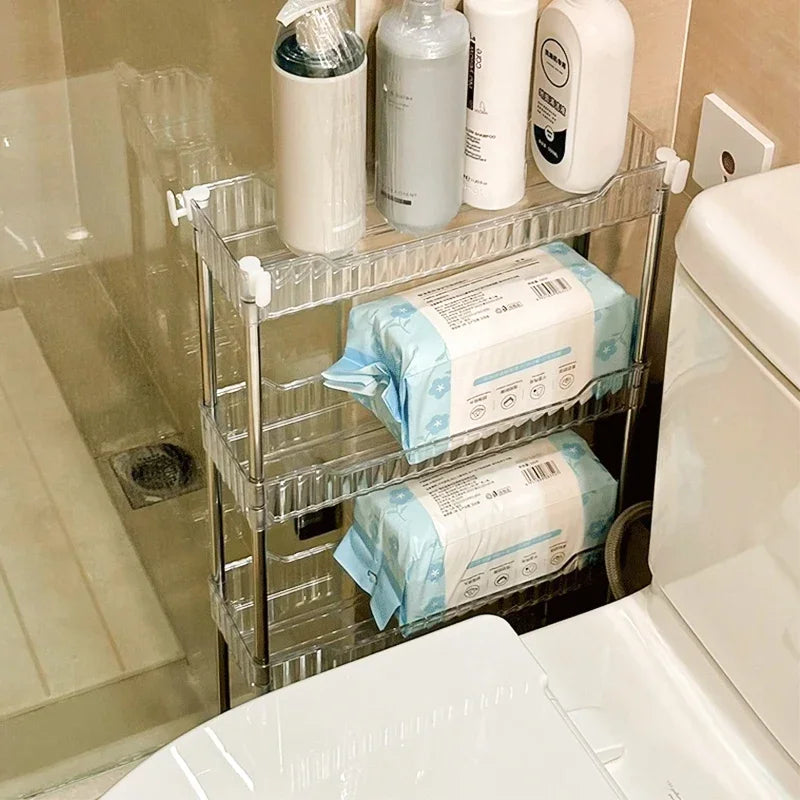 Luxury acrylic storage trolley with three clear shelves holding toiletries and wipes in a bathroom