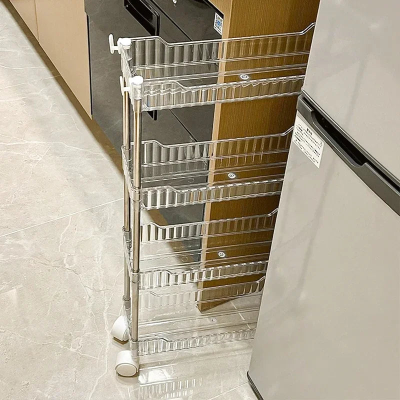 Clear luxury acrylic storage trolley with multiple shelves and white wheels placed in kitchen space
