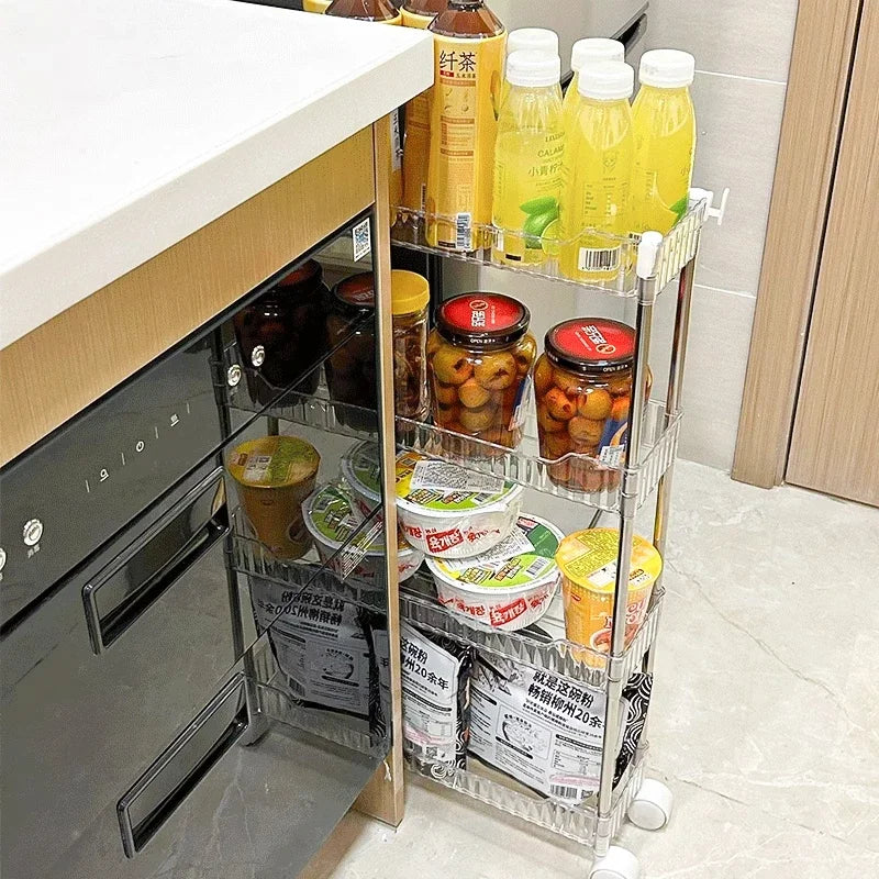 Luxury acrylic storage trolley by Clarify.pk with three tiers holding bottles, jars, and packaged food in kitchen