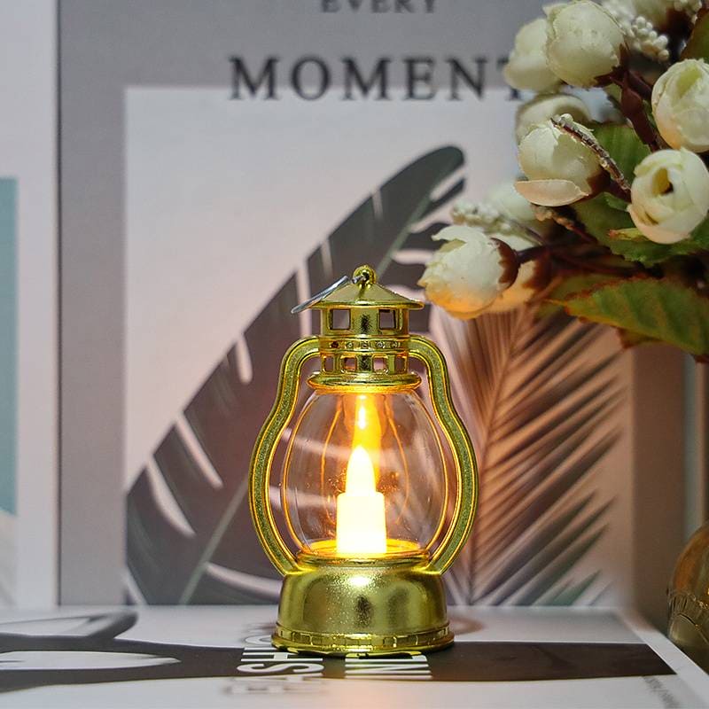 Gold mini lantern lamp for home decor with warm glowing light on a decorative table