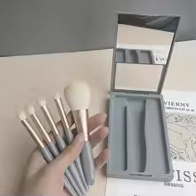 mini makeup brush set with case featuring various brushes and a compact mirror for easy application