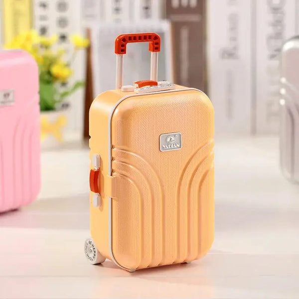 Clarify.pk mini musical jewelry box shaped like a small orange suitcase with handle and wheels