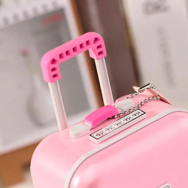 Pink mini musical jewelry box with a retractable handle and silver chain detail