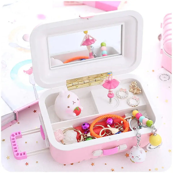 Pink mini musical jewelry box with a ballerina figurine, mirror, and various jewelry items inside
