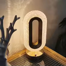 Modern luxurious nordic desk lamp with oval design and textured surface on wooden table