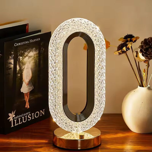 Modern luxurious nordic desk lamp with crystal oval design and warm light on wooden table