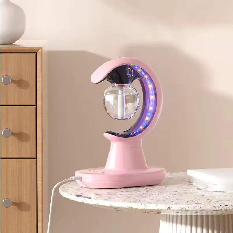 Pink moon shaped humidifier night lamp with LED lights on a round table beside wooden drawers