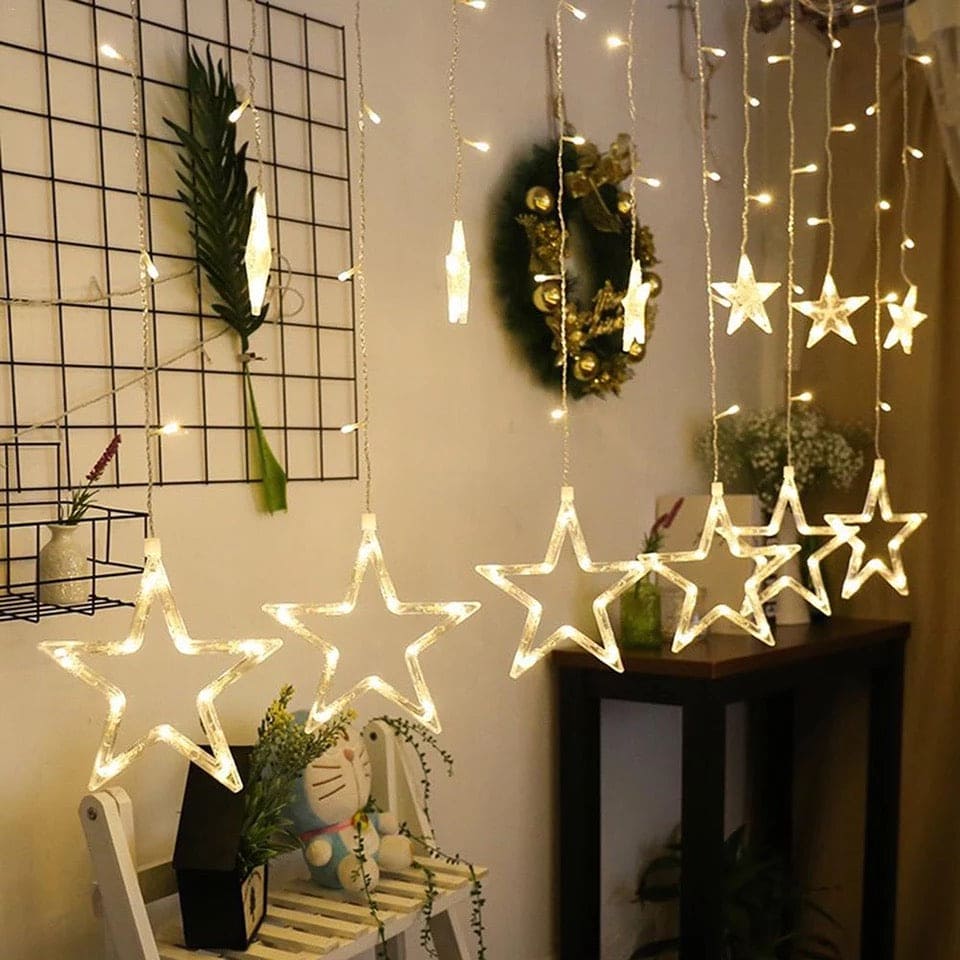 Warm white moon star curtain lights hanging indoors for decorative lighting