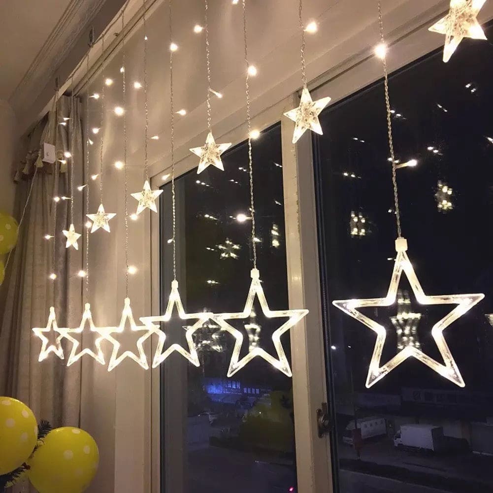 Clarify.pk moon star curtain lights hanging by window with glowing star shapes and warm white bulbs