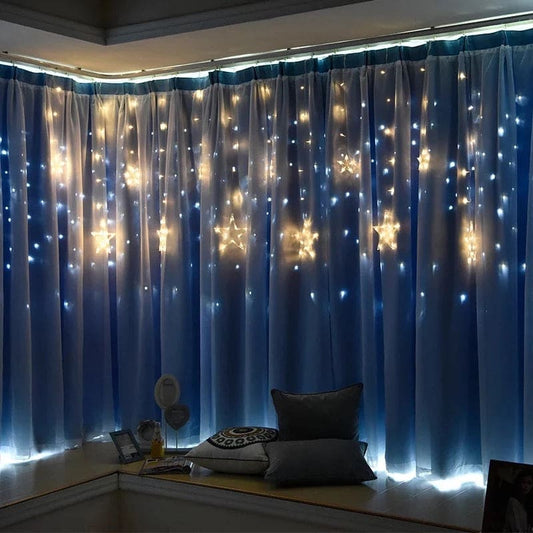 Blue curtains decorated with warm white glowing moon star curtain lights creating cozy room ambiance