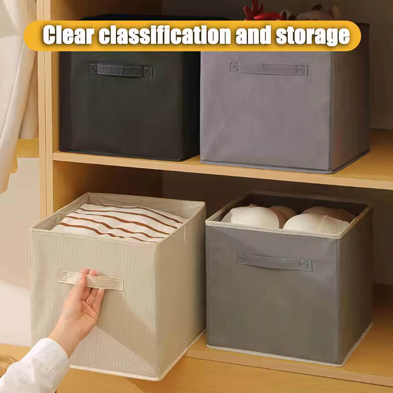 Non-woven storage basket with handle in beige and gray colors used for organizing clothes on wooden shelves