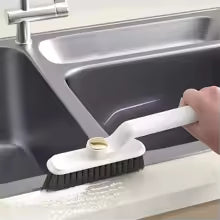 Multi-function crevice cleaning brush with white handle cleaning sink edges and corners