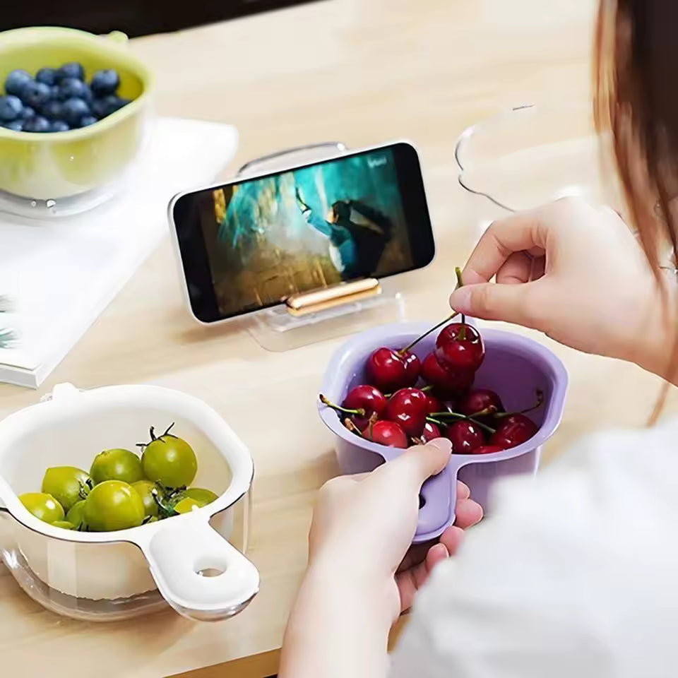 Clarify.pk multi-functional drain basket in purple and white holding cherries and green tomatoes on a kitchen table