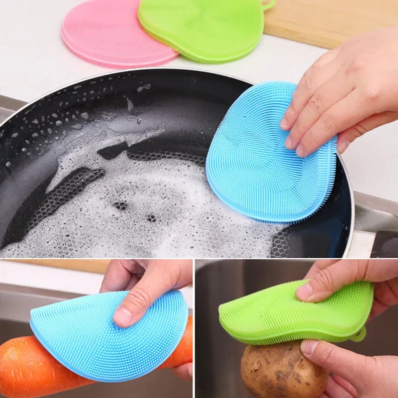 Clarify.pk multi-functional kitchen scrubber in blue and green cleaning a pan, carrot, and potato