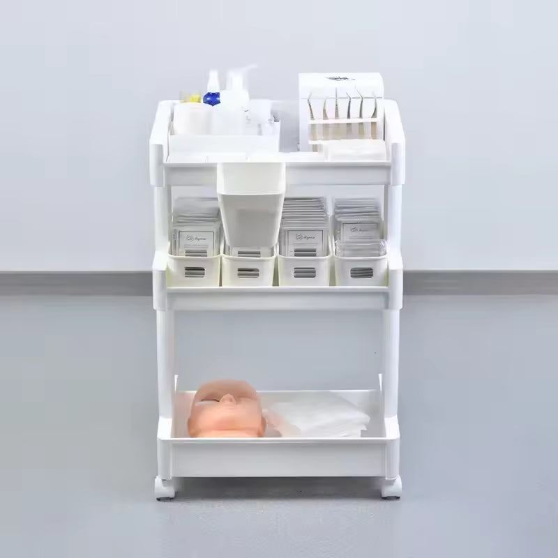 White multi-layer drawer trolley with multiple compartments filled with various storage items