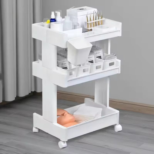 White multi-layer drawer trolley with wheels holding various bottles and supplies by Clarify.pk