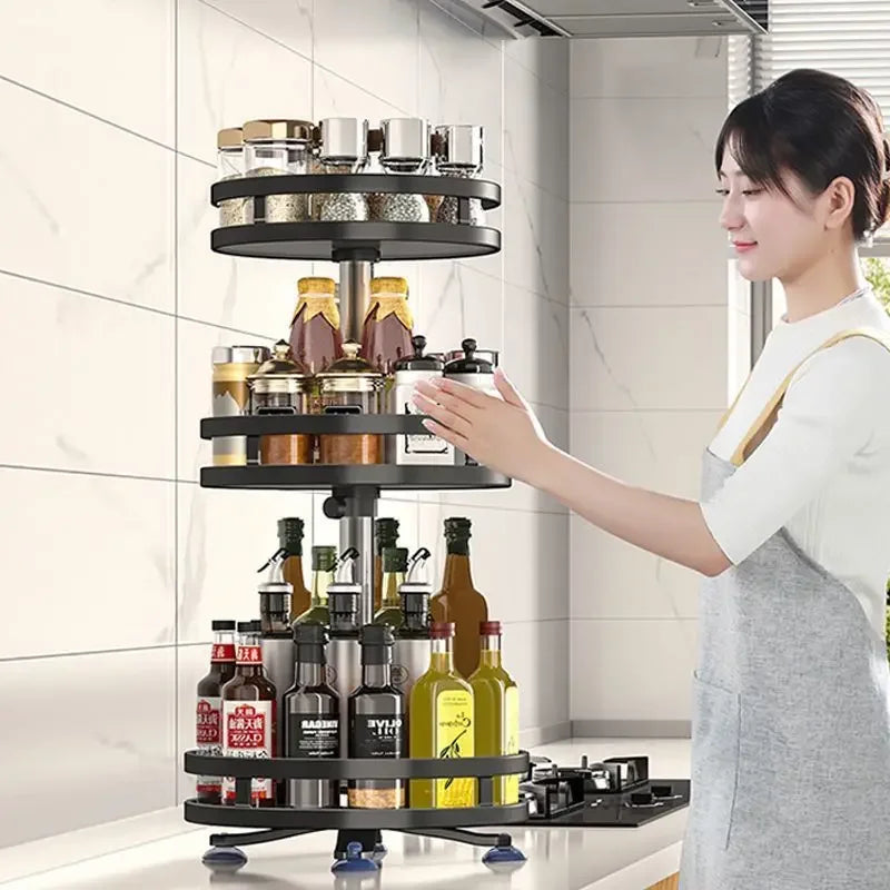 Black multi-layer kitchen storage organizer holding jars and bottles on a modern kitchen counter